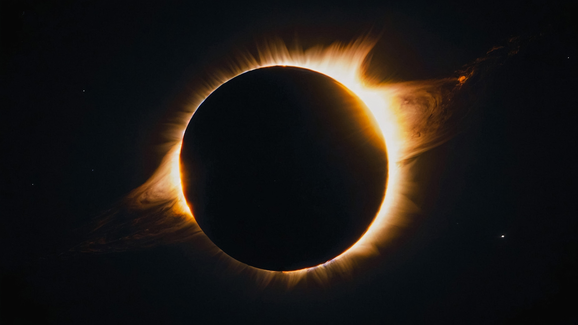 The solar corona during a total eclipse, the pearlescent halo visible when the Moon fully covers the Sun